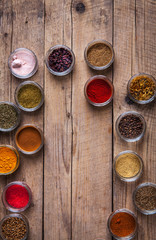 Spices in jars on wooden background. Food