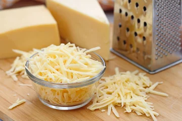 Gordijnen Grated cheese in a glass bowl © lisa870
