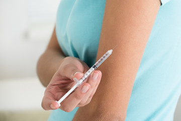Diabetic Young Woman Injecting Arm