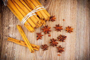 Cinnamon stick and star anise on wooden background