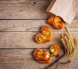 Delicious Breakfast, a pretzel with coffee on wooden background. The food, the drinks.