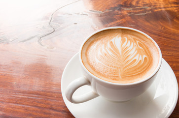 Hot coffee with flower from milk foam.