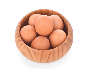egg in a wooden bowl isolated on white background