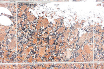 Winter background stone granite slabs covered with snow. Medium shot