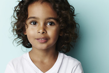 Young boy on blue background, portrait