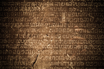 Ancient Thai writing chiseled on stone