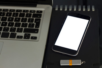 Office table with laptop, phone and supplies