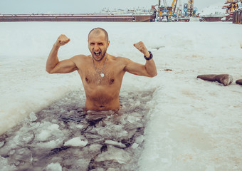 A man swims in the winter