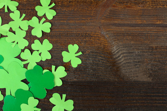 Green Shamrocks clovers on wooden background . Background for St. Patrick's Day celebration