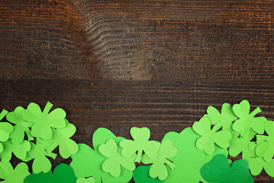 Green Shamrocks clovers on wooden background . Background for St. Patrick's Day celebration