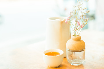 Cup of hot tea on wooden table , soft focus