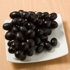 grape on wooden table,black grape