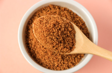 Coconut sugar in a cup with pink background
