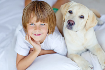 kid are playing with dog at home 