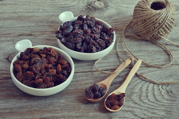 Dried raisins Turkish and Spanish (Malaga). Turkish raisins, Sultan raisins pitted . Raisins from Malaga with stones. Dried raisins on the wood backgraund