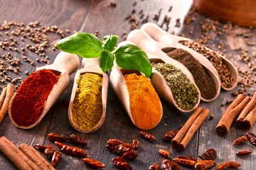 Fotobehang Aroma Variety of spices on kitchen table