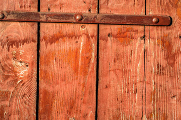 Background texture of wooden planks painted in red color.