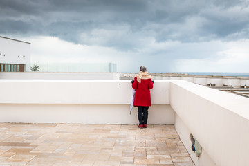 Women is looking at the horizon on a winter day