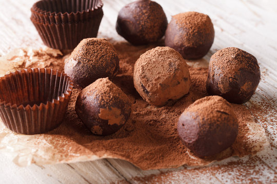 French Chocolate truffles with cocoa powder close-up paper. horizontal 
