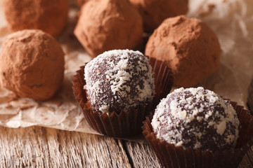 Chocolate truffles in cocoa and nuts macro on a table. horizontal
