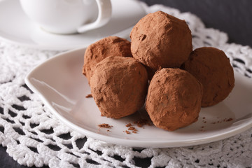 Chocolate truffles on a saucer close-up. horizontal

