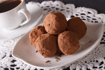 Chocolate truffles close-up and coffee on the table. Horizontal
