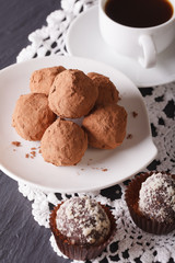 Gourmet food: chocolate truffles and coffee close-up. vertical
