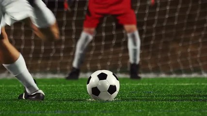 Close up of a soccer player making a penalty kick and his teammates congratulating him - Powered by Adobe