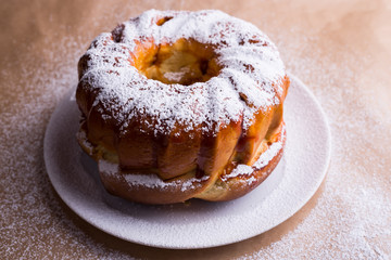 yeast cake with icing sugar on a plate