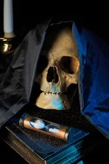 Fotobehang Oude meesters human skull on a book next to the clock. concept of black magic  © kopitinphoto