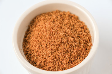 Coconut sugar in a cup with white background