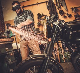 Mechanic doing lathe works in motorcycle customs garage