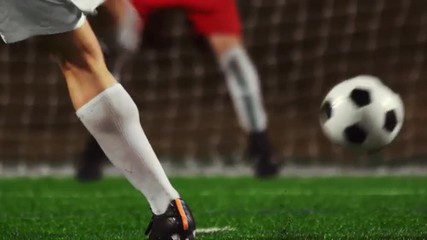 Close up of a soccer player making penalty kick into the goal