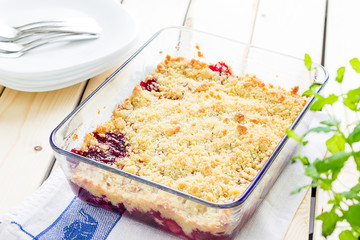 Strawberry and Raspberry Crumble on a Light Wooden Background, Horizontal