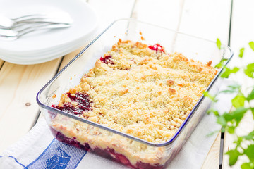 Strawberry and Raspberry Crumble on a Light Wooden Background, Horizontal