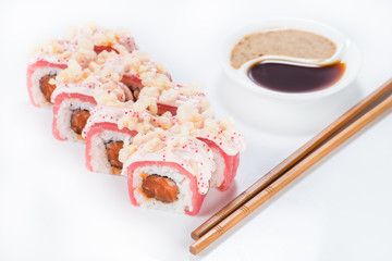 closeup roll sushi with chopsticks and soy sauce (shallow DOF)