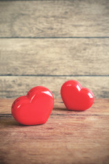 Red heart shape on old wooden background