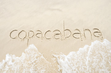 Copacabana, the famous beach, message handwritten on smooth sand in Rio de Janeiro, Brazil