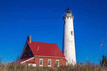 American Lighthouse. The Tawas Point Lighthouse surrounded by dune grass in Tawas City, Michigan.