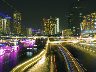 Fototapeta na wymiar traffic in the river on night city skyline background