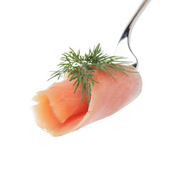 Salmon piece with dill on a fork isolated on white