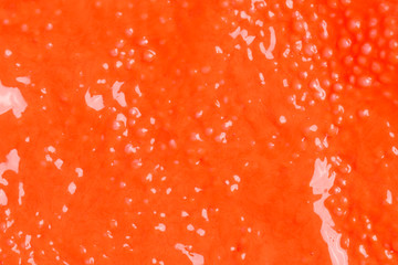Colorful background - textured orange wet plasticine - irregular pattern