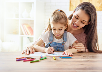 Mother and daughter together paint