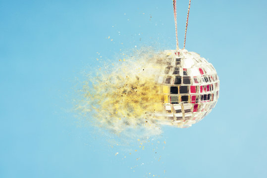 Exploding disco ball on blue background