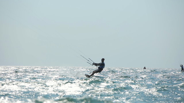 Surfer Doing Stunts While Kitesurfing