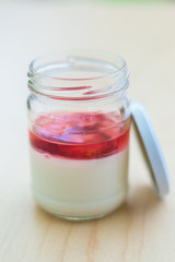 Beautiful strawberry dessert in a jar on light Board