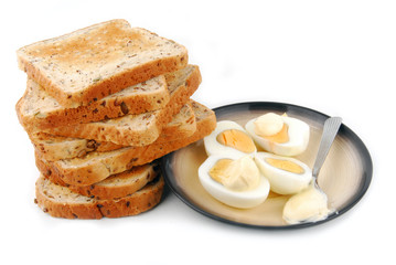 eggs and bread slices on plate isolated
