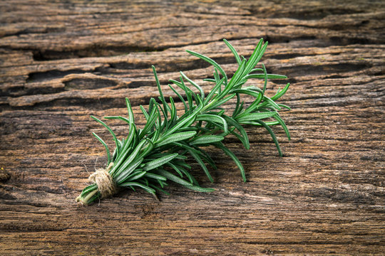 Fresh green Rosemary bound on a wooden board
