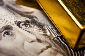 Close-up of a 20-dollar banknote (figuring president Jackson) and gold ingots
