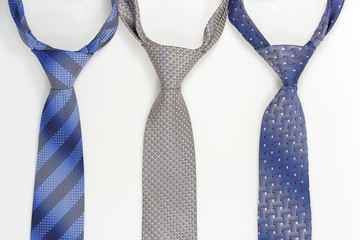 Group of colorful neckties on white